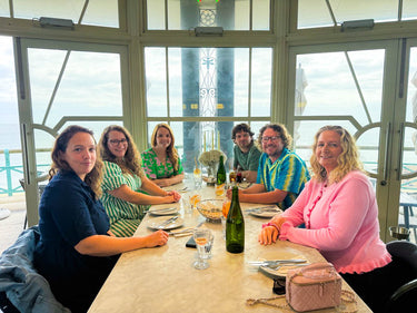 The Harry Batten team having lunch together by the sea