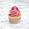 Raspberry Cupcake with pink buttercream, raspberry drizzle and freeze dried raspberries, on marble