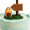 Hiking Cake with a fondant rucksack and 50 signpost on buttercream grass and mountain sides