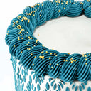 8 inch Stencil Cake with a teal stencilled leaf design, buttercream swirls and gold pearls