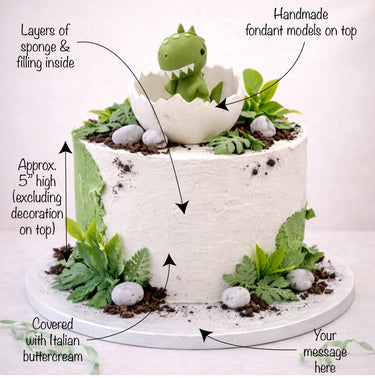 Free From Baby Dino Cake with white and green buttercream, chocolate crumb soil, fondant stones and a hatching dinosaur