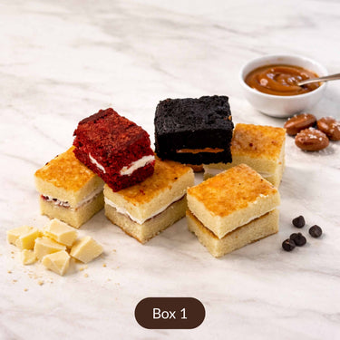 Sample Taster Box slices, including red velvet, chocolate caramel and blondie, on marble