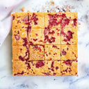 16 White Chocolate and Raspberry Blondies with raspberry swirls
