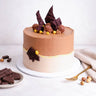 Ferrero Rocher Cake topped with chocolate shards, Ferrero Rocher and hazelnuts, with dark chocolate and a gold fork