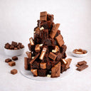 Brownie Tower of stacked brownies with melted chocolate drizzle and chocolate pieces