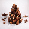 Brownie Tower of stacked brownies with melted chocolate drizzle and chocolate pieces