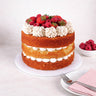 Victoria Sponge Cake with three layers of sponge, buttercream and jam, topped with strawberries and raspberries