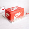 Shoe Box Cake made to look like a red trainer box, with a birthday message on a silver board