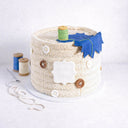 Needlecraft Cake made to look like a knitting basket, with edible buttons, a cotton reel and fabric