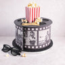 Movie Cake designed as a film reel, with a popcorn box, 3D glasses and fondant film strip
