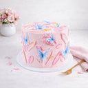 Free From Butterfly Cake with pink buttercream, gold pearls and edible butterflies