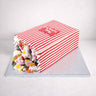 Sweety Box Cake made to look like a tipped over sweet bag, with colourful sweets spilling out