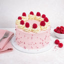 Mini Raspberry White Chocolate Cake with buttercream rosettes, fresh raspberries and sugar pearls