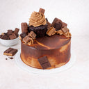 Mini Chocolate Overload Cake topped with a chocolate cupcake, broken chocolate bars and sweets