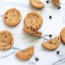 Chocolate Chip Cookies, whole and broken, on marble