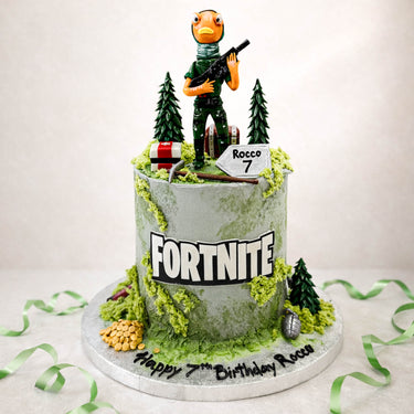 Fortnite birthday cake with a character figure, trees and loot