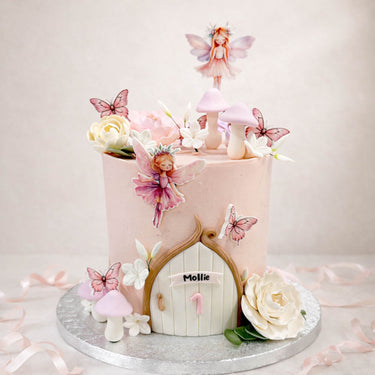 Fairy door cake with butterflies, mushrooms and a fairy