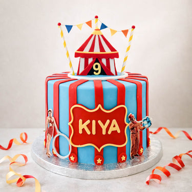 Circus birthday cake with a big top, bunting and red and blue stripes