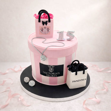 Pink striped 15th birthday cake with sugar gift bags