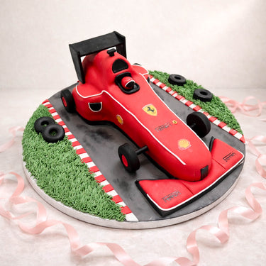 Red Formula 1 racing car cake on a race track