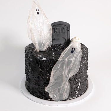 Tombstone Cake with rustic black buttercream, ghosts, an RIP tombstone and a skull