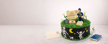 Jolly Postman themed cake with a green hedge, night sky and letters