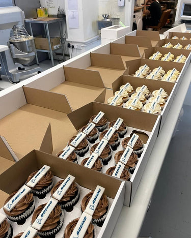 Boxes of custom cupcakes packed up for a Boeing order