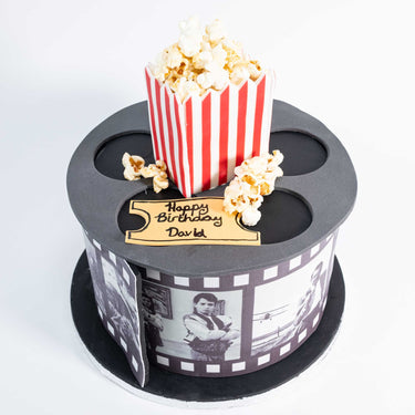 Film reel Movie Cake with a popcorn box, edible ticket and fondant film strip