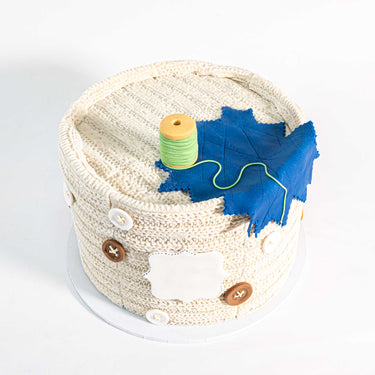 Needlecraft Cake with piped stitches, edible buttons, a fondant cotton reel and fabric swatch