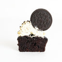 Oreo Cupcake cut in half, showing chocolate sponge, topped with vanilla buttercream and an Oreo