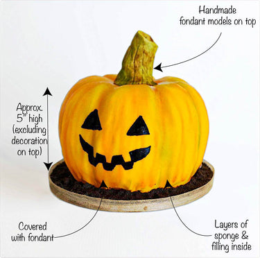Pumpkin Cake covered in orange fondant with a jack o'lantern face and a fondant stalk