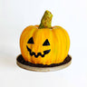 Pumpkin Cake shaped like a jack o'lantern, sitting on crumbled chocolate