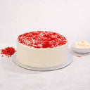 Red Velvet Cake with smooth white buttercream and red velvet crumbs on a silver board