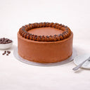 Chocolate Cake with piped buttercream and chocolate chips on a silver board