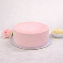 Rose and Elderflower Cake with pale pink buttercream and white sugar pearls, next to a rose