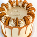 Lotus Biscoff Cake with caramel drip and Biscoff biscuits, with a piped happy birthday message