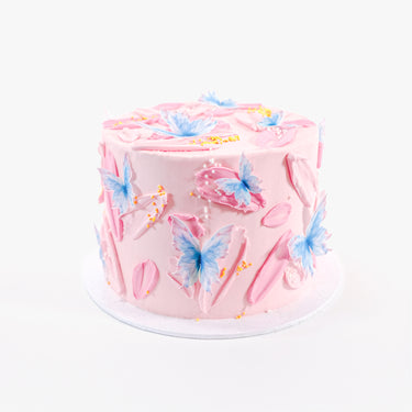 Butterfly Cake with pink buttercream, wafer paper butterflies and gold sprinkles