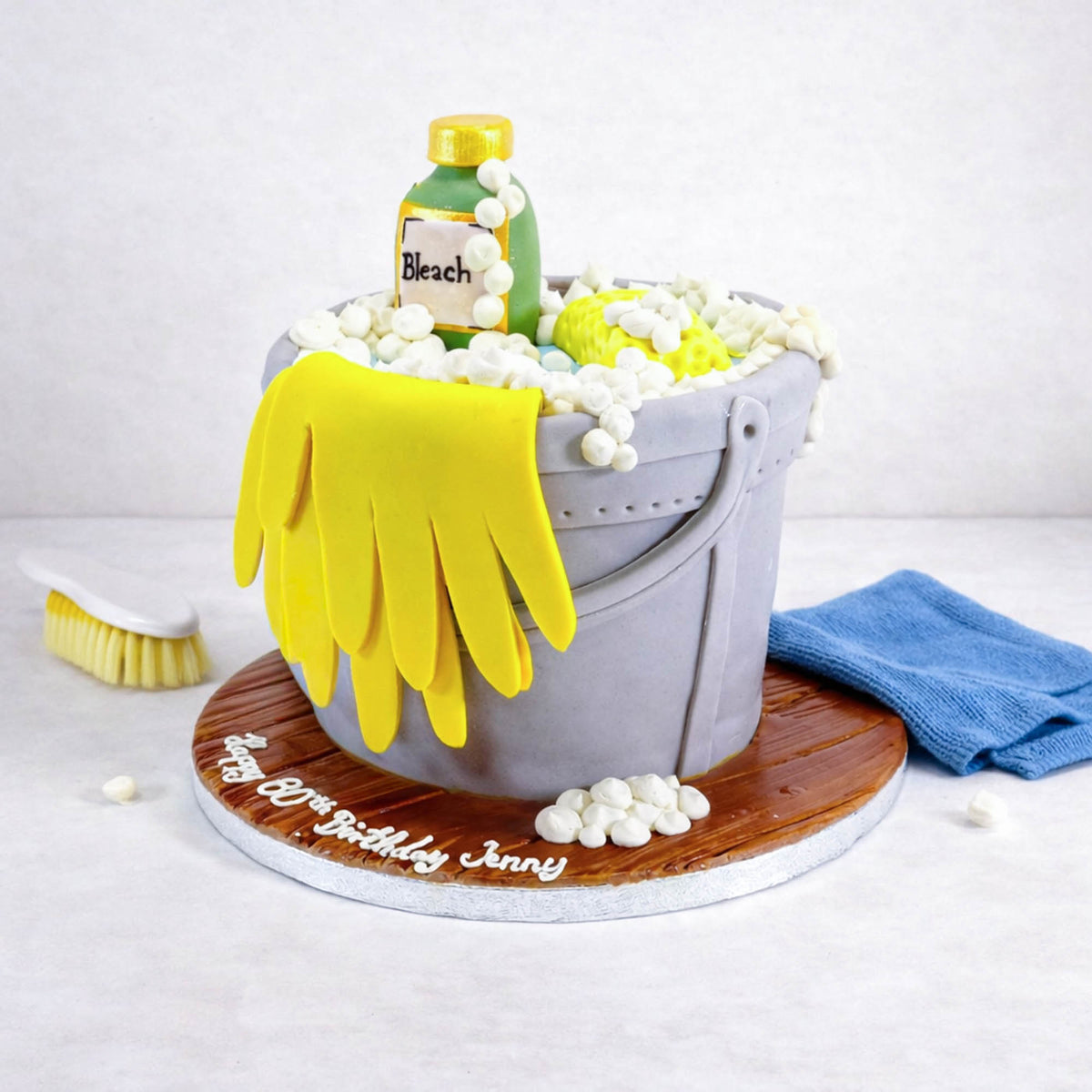 Free From Cleaning Bucket Cake made to look like a cleaning bucket, with sugar rubber gloves, a sponge and a bleach bottle