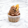 Banana, Chocolate and Hazelnut Cupcake with Nutella buttercream, chopped hazelnuts, a banana chip and chocolate drizzle