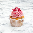 Raspberry Cupcake with pink buttercream, raspberry drizzle and freeze dried raspberries, on marble