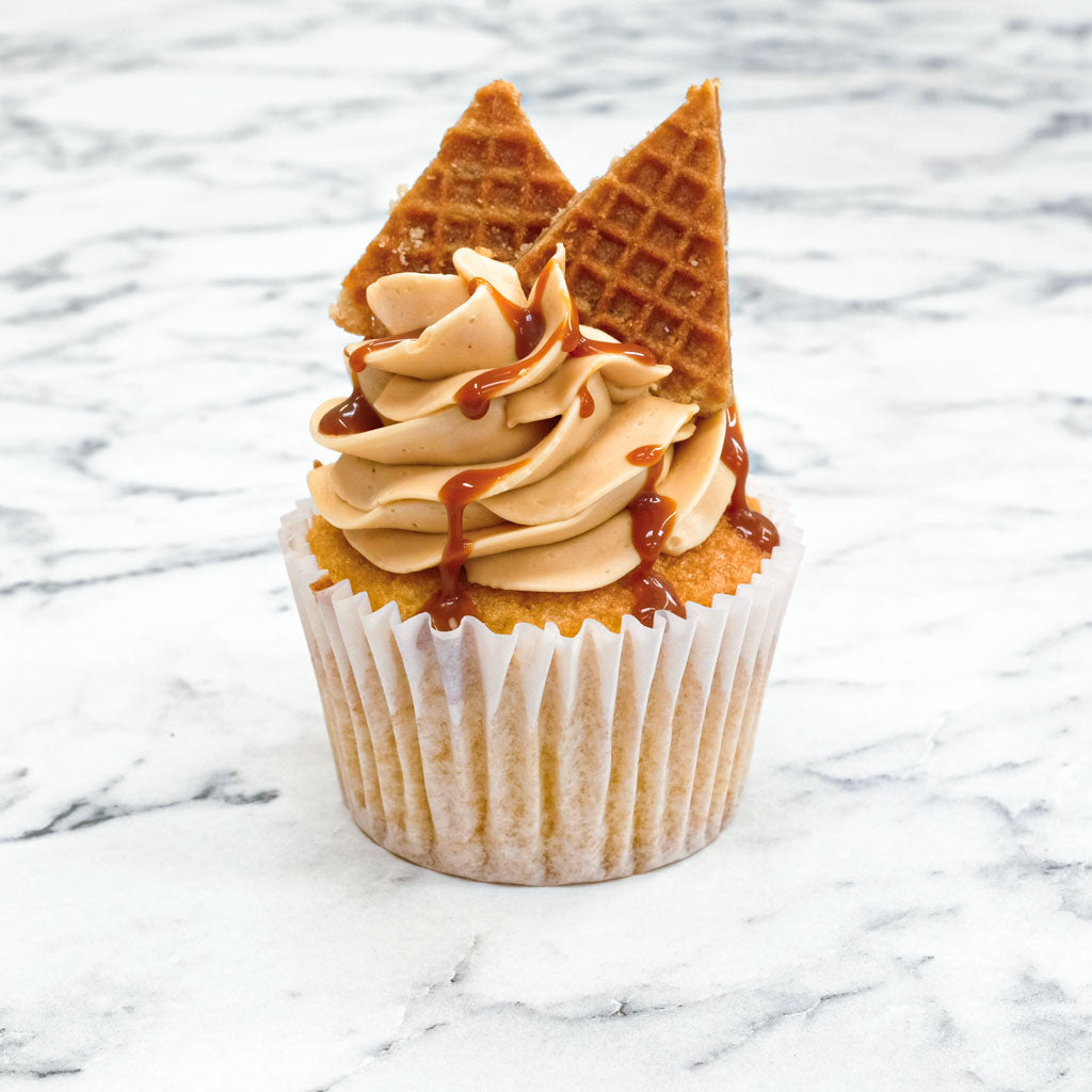 Salted Caramel Cupcake with caramel buttercream, caramel drizzle and stroopwafel pieces, on marble