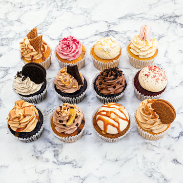 12 Mixed Cupcakes with different toppings, including macarons and Oreo biscuits