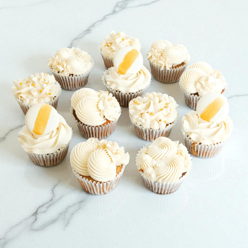White and Gold Cupcake Mix with ivory buttercream, gold sugar pearls and macarons