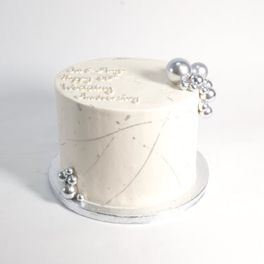 Silver Cake with smooth white buttercream and metallic silver pearls