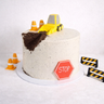 Vegan Free From Digger Cake with a fondant digger, traffic cones and barriers on speckled buttercream
