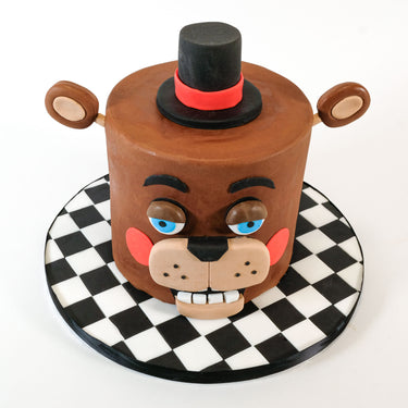 Five Nights at Freddy's Cake, a brown fondant bear head with blue eyes and a top hat