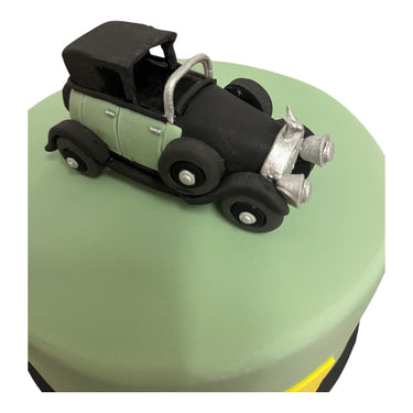 Custom cake with pale green buttercream and a fondant vintage convertible car on top