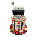 Custom Las Vegas wedding cake with a Little White Chapel topper and a Vegas sign