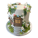 Custom fairy door cake with fondant greenery, flowers and butterflies