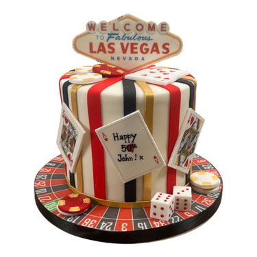 Custom 50th birthday casino cake with playing cards, poker chips and a roulette wheel base